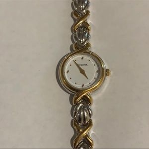 Bulova watch 
Delicate white faced watch with woven bracelet 
6 3/4 
1/4 width